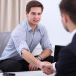 Business people handshake, sitting in the office