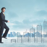 Business man climbing up on hand drawn buildings in city