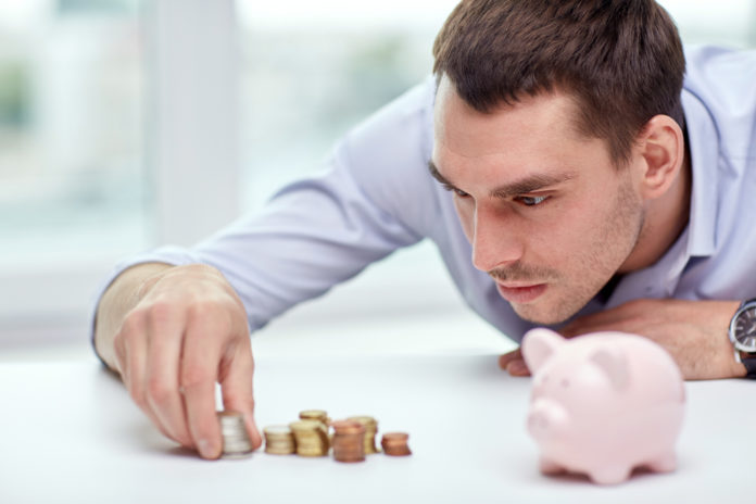 businessman with piggy bank and coins at office
