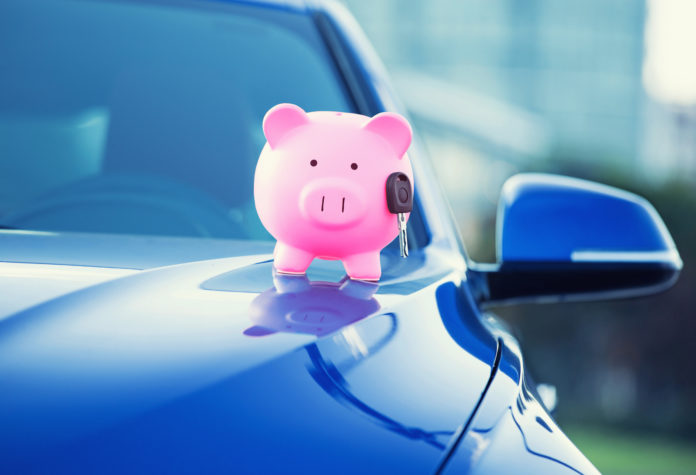 new car with piggy bank, key on hood