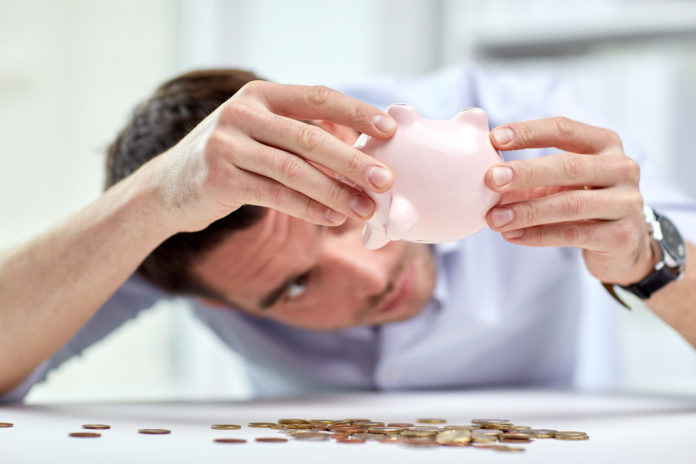 businessman with piggy bank and coins at office